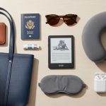 Neatly packed travel tote bag with pouches, water bottle, and travel essentials laid out flat